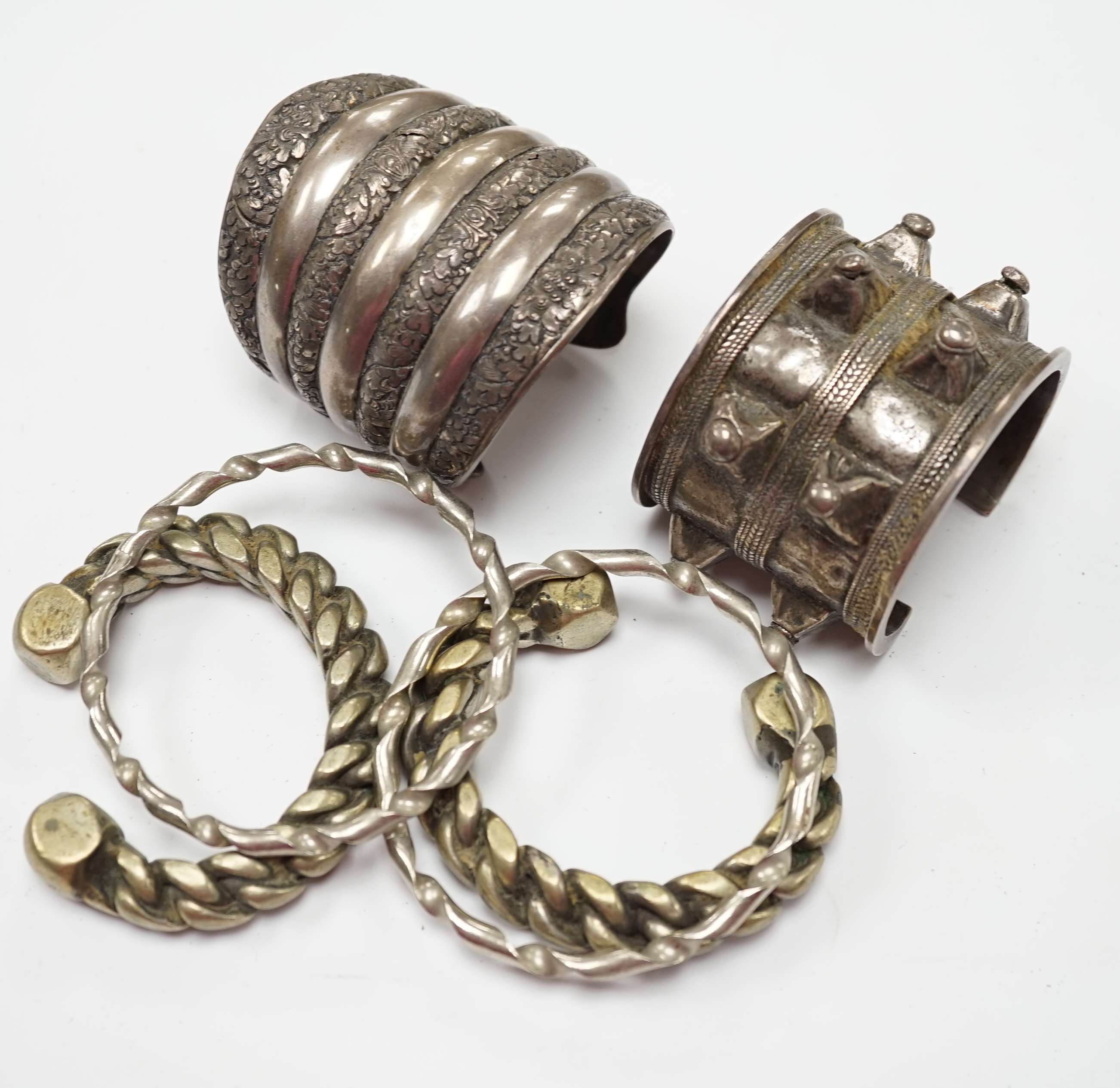Six assorted Egyptian bracelets, including white metal bangles and two white metal cuff bracelets. Fair condition.